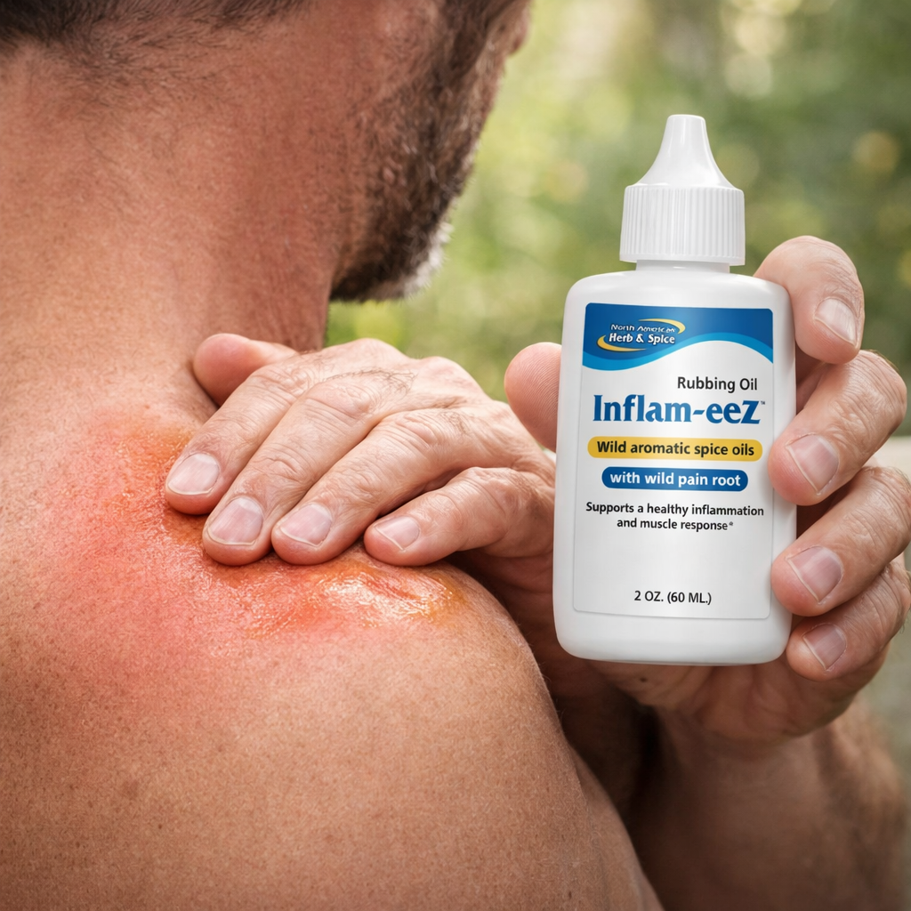 Man applying Inflam-eeZ oil to a sore shoulder outdoors